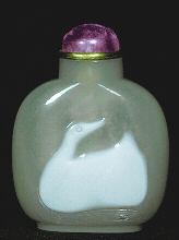 A chalcedony well hollowed cameo carved picture snuff bottle with white skin representing a duck, Chinese, 1750-1850.  Amethyst stopper. 