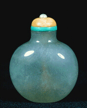A flawless grey jadeite snuff bottle, superbly hollowed eggshell thin, with a pink coral on a turquoise collar stopper.  Chinese, 1730-1780.